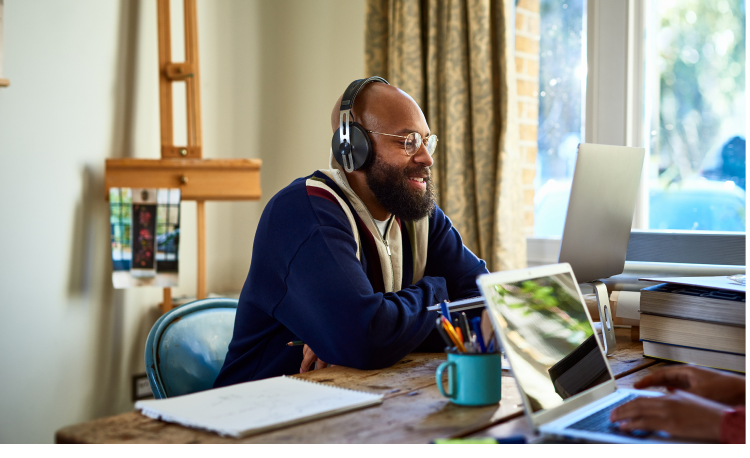 A young man watching his laptop, Internet services powered by Brightspeed.