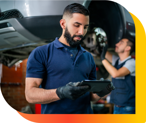 Mechanic with a tablet in a workshop