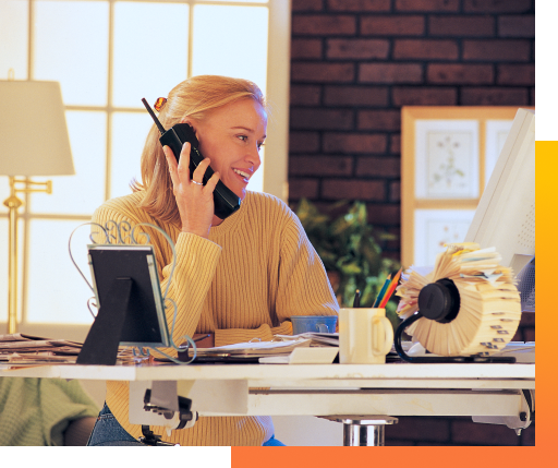 person on the phone looking at computer